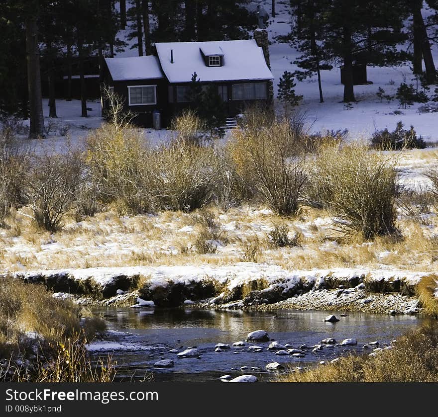 Small cabin inside national park with a light dusting of snow. Small cabin inside national park with a light dusting of snow.