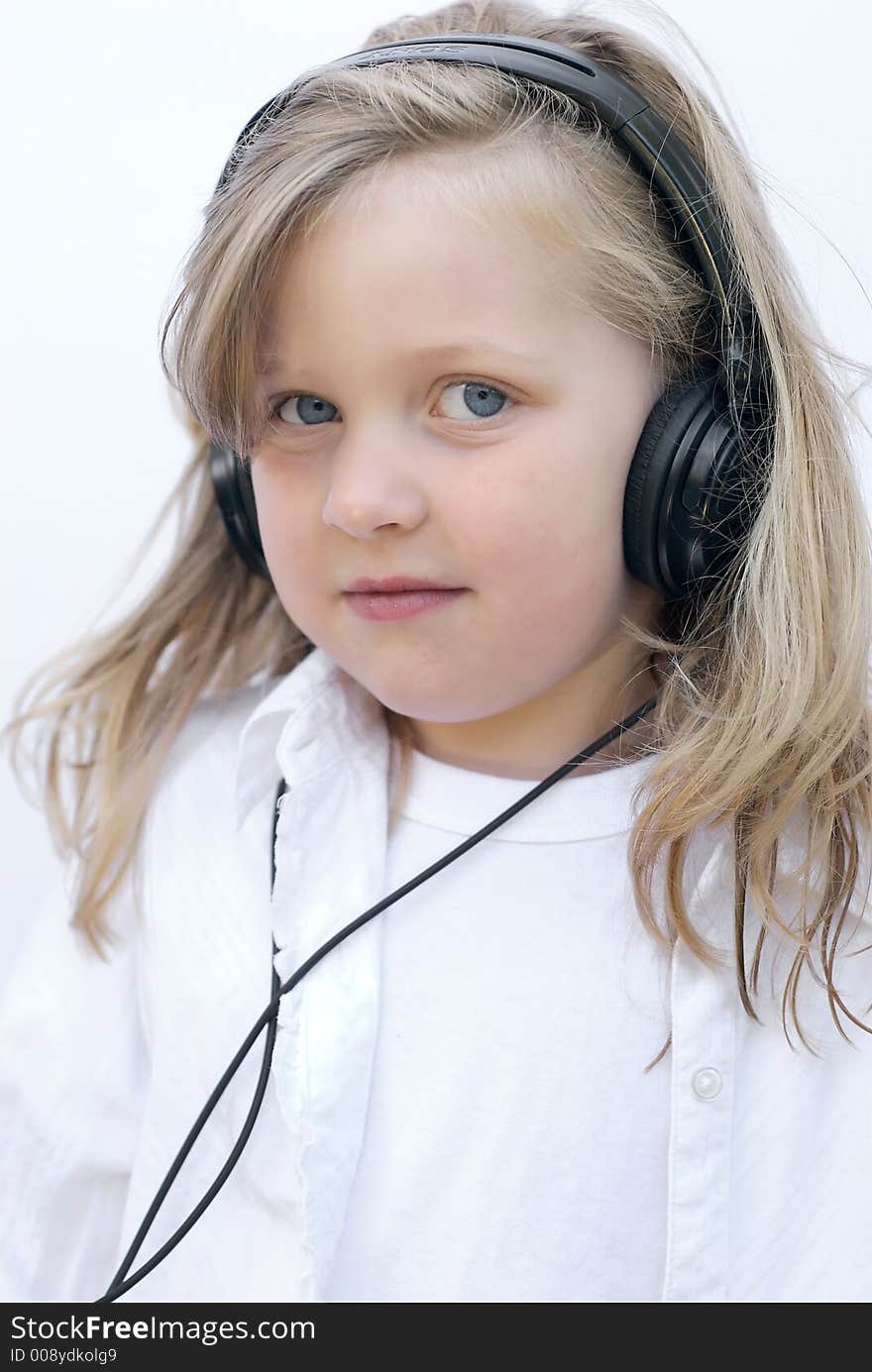 Young girl isolated on white wearing headphones. Young girl isolated on white wearing headphones