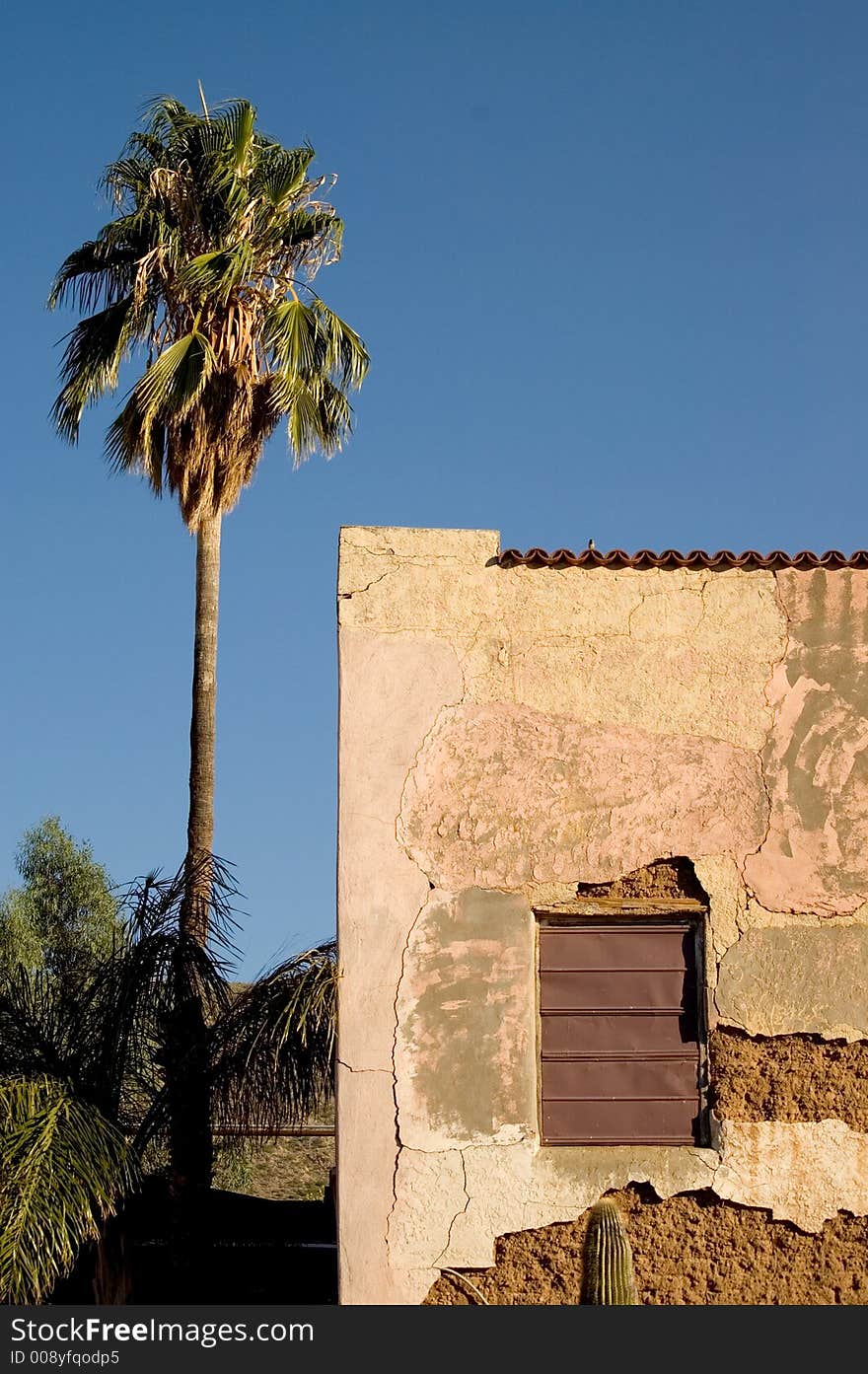 Historic motel in ruins wth lone palm tree standing next to it. Historic motel in ruins wth lone palm tree standing next to it