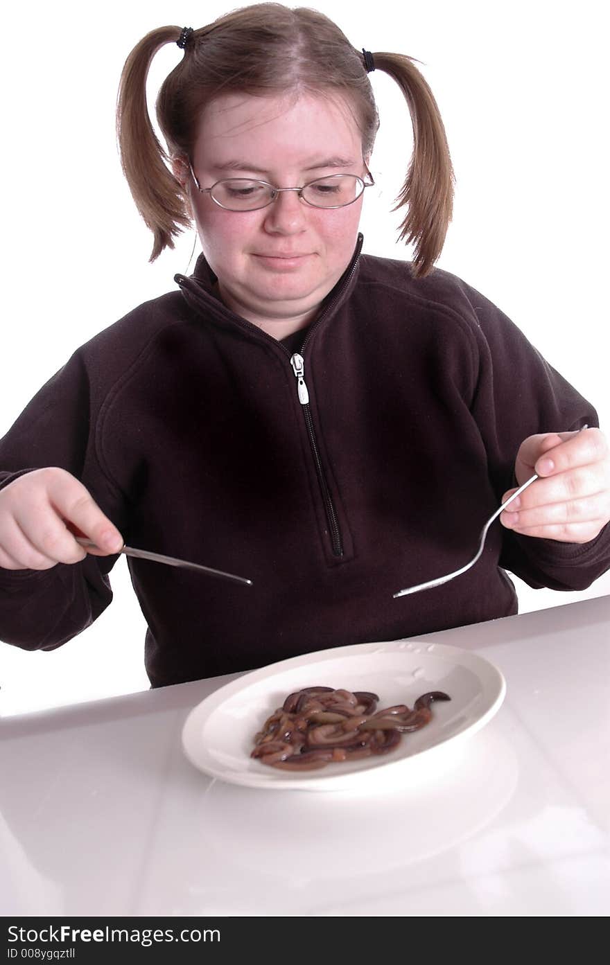 A woman eating a plateful of worms. A woman eating a plateful of worms.