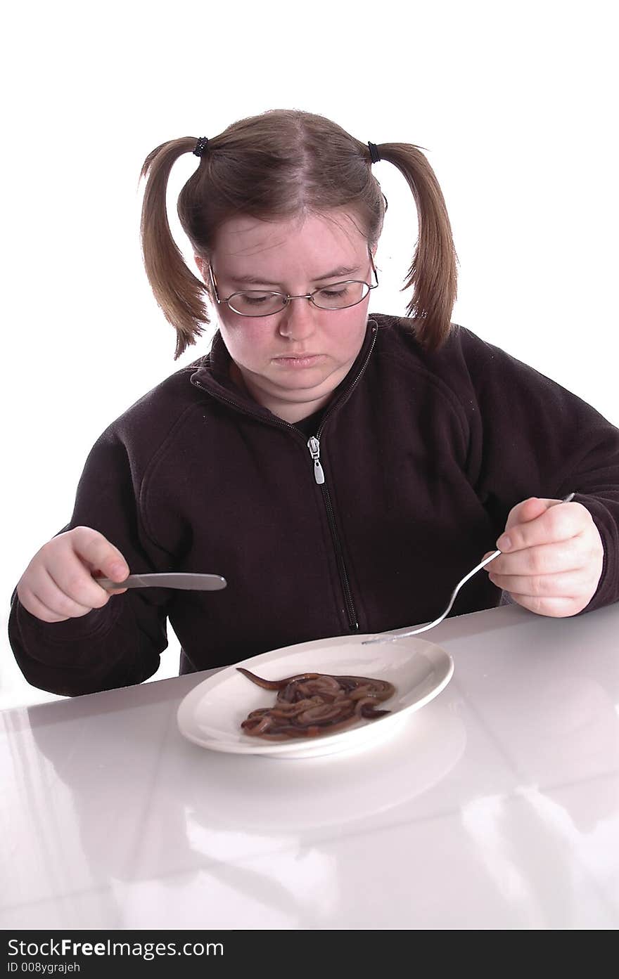 A woman eating a plateful of worms. A woman eating a plateful of worms.