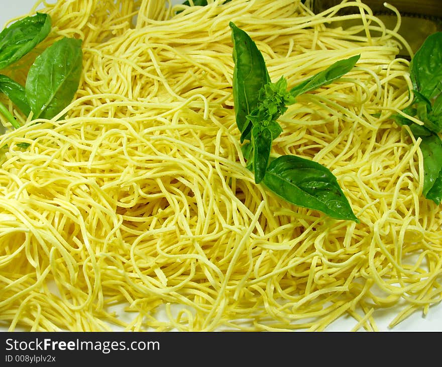 Spaghetti whit green fresh basil leaves. Typical italian food. Spaghetti whit green fresh basil leaves. Typical italian food