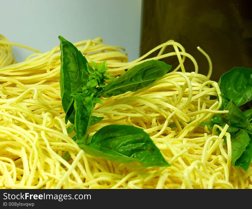 Spaghetti whit green fresh basil leaves. Typical italian food. Spaghetti whit green fresh basil leaves. Typical italian food