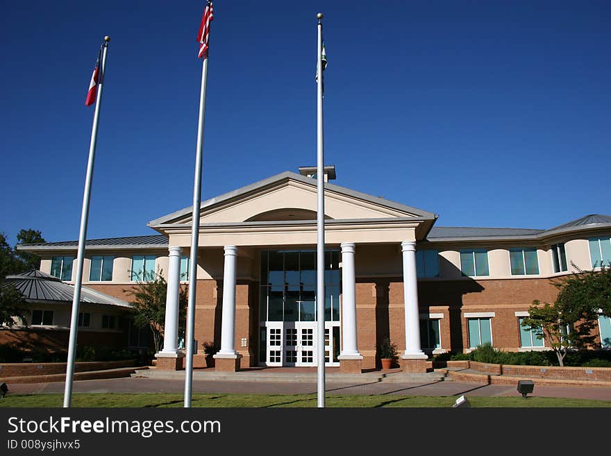 Modern Brick City Government building with flags. Modern Brick City Government building with flags