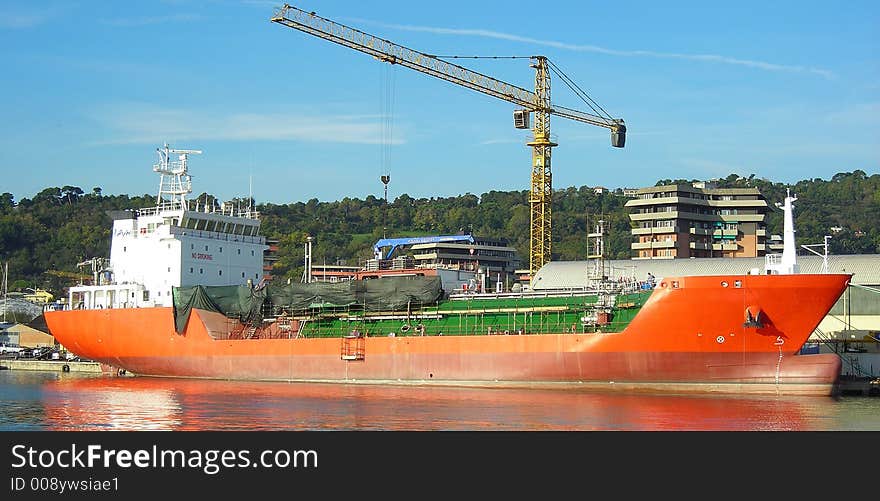 Big red cargo boat in shipyard. Big red cargo boat in shipyard...