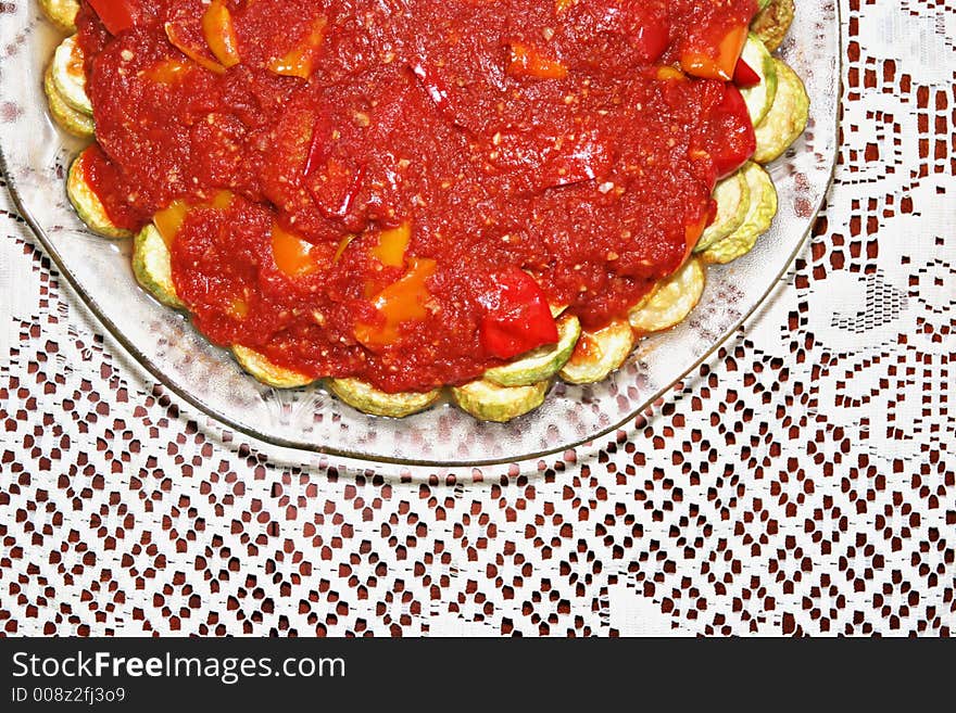 Plate of zucchinis with tomato sauce