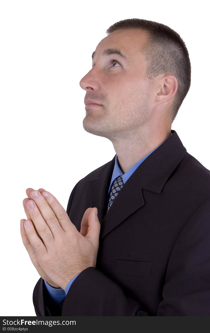 A business man is praying. A business man is praying