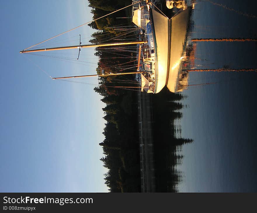 Boat reflection in sunset, next to a park