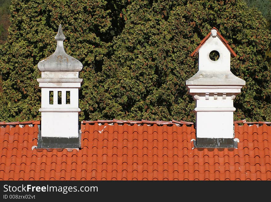 Ornamental chimneys on red roof