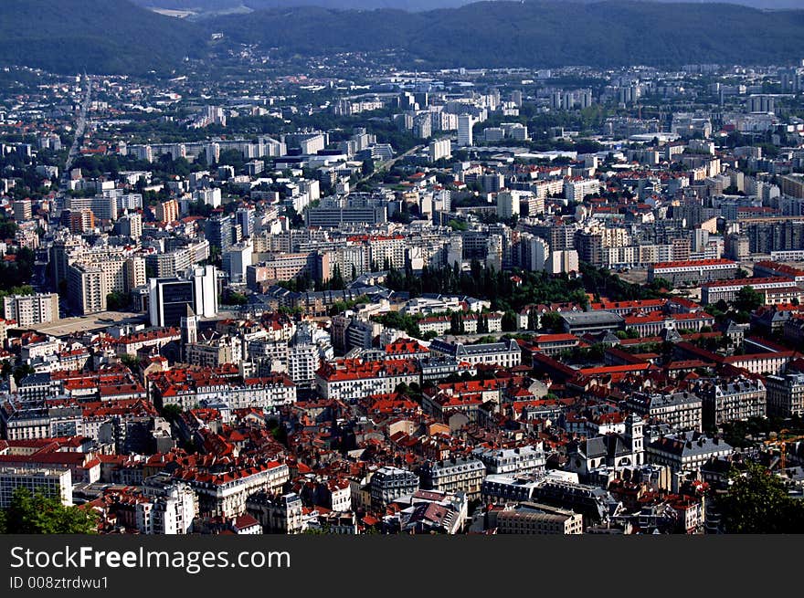 High-ground view of a city in the valley of mountains. High-ground view of a city in the valley of mountains.