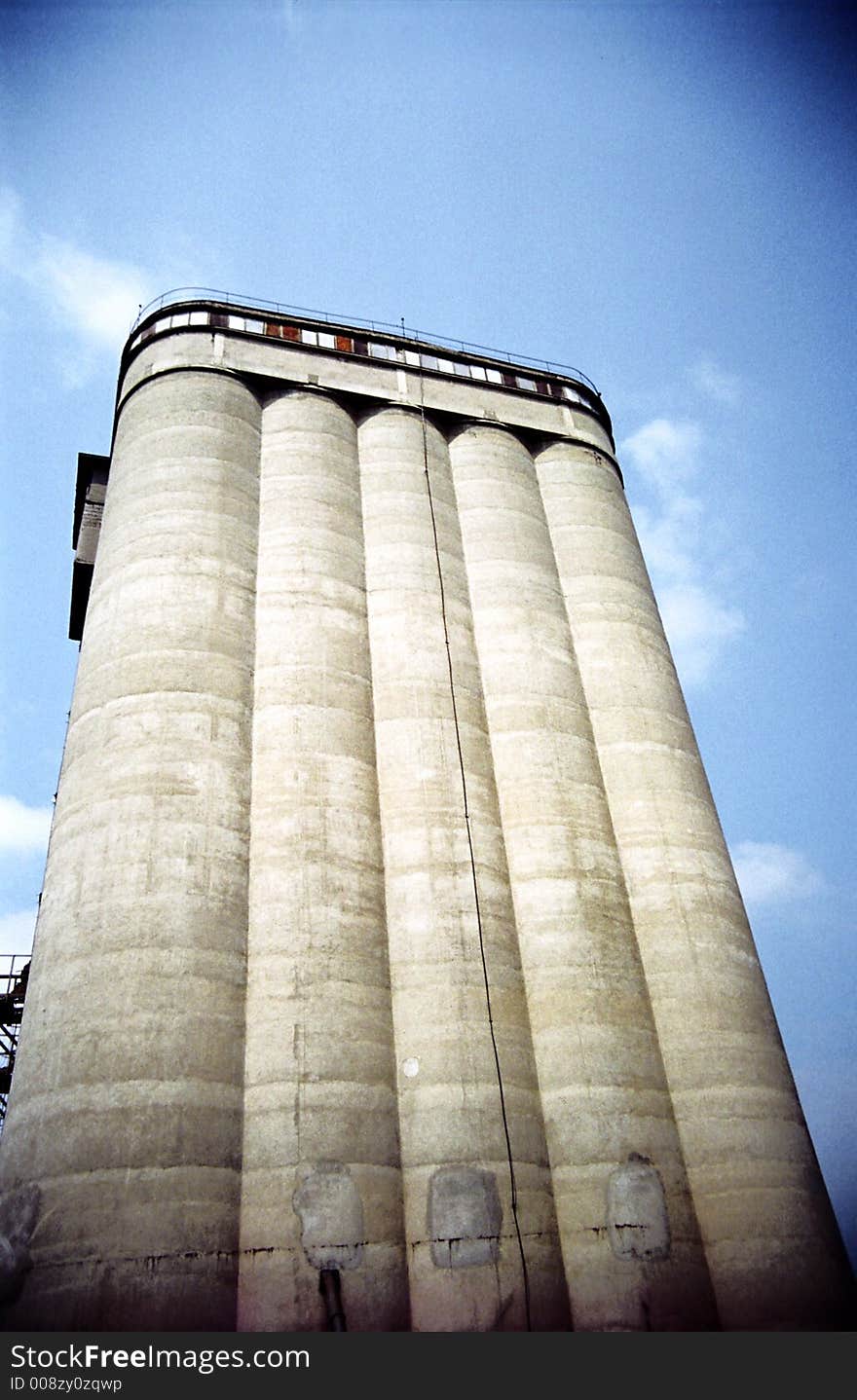 Impressively tall cereal storage silo, perspective view with vignette. Film scan. Impressively tall cereal storage silo, perspective view with vignette. Film scan.