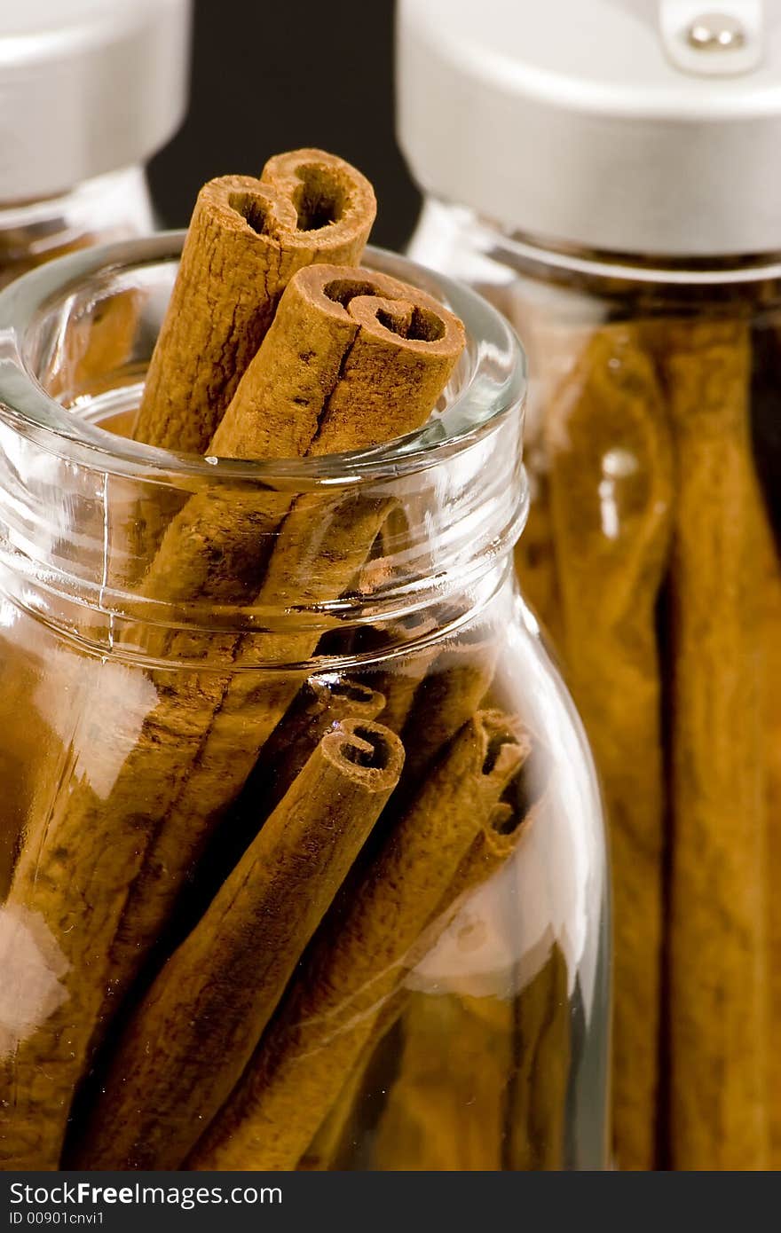 Cinnamon sticks in glass pots, studio shot, close up