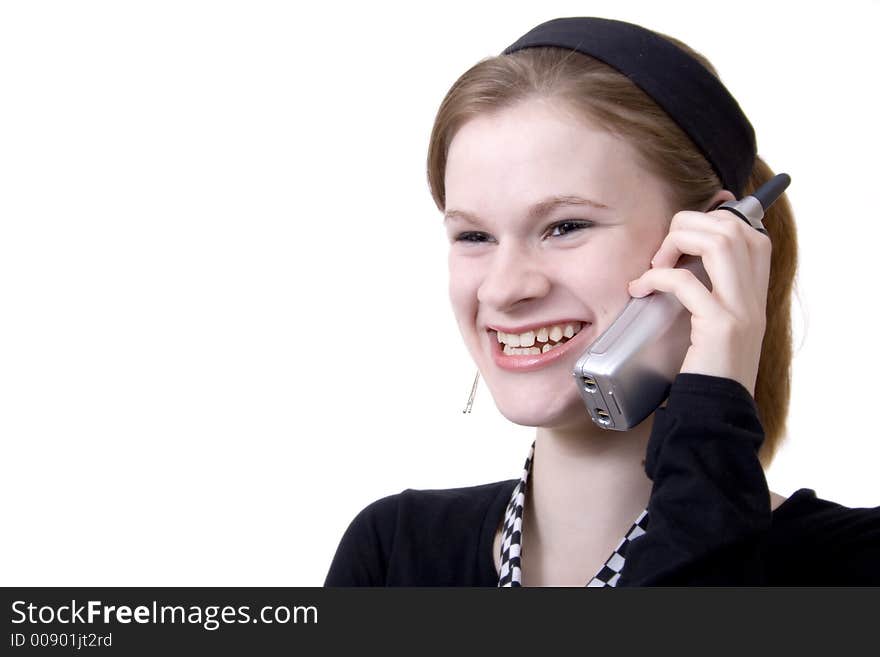 Attractive teen smiling and talking on the phone. Attractive teen smiling and talking on the phone.