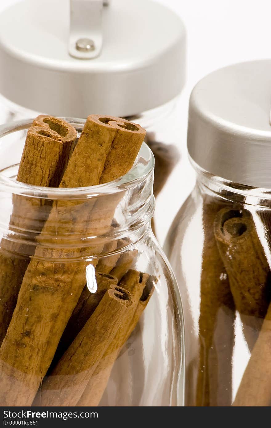 Cinnamon sticks in glass pots, studio shot, close up