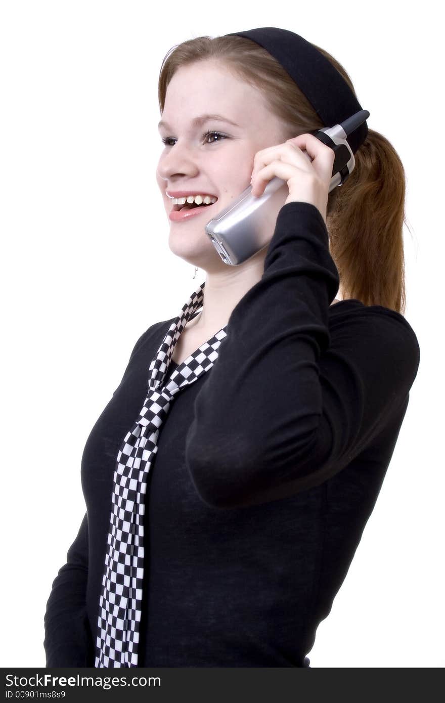 Attractive teen smiling and talking on the phone. Attractive teen smiling and talking on the phone.