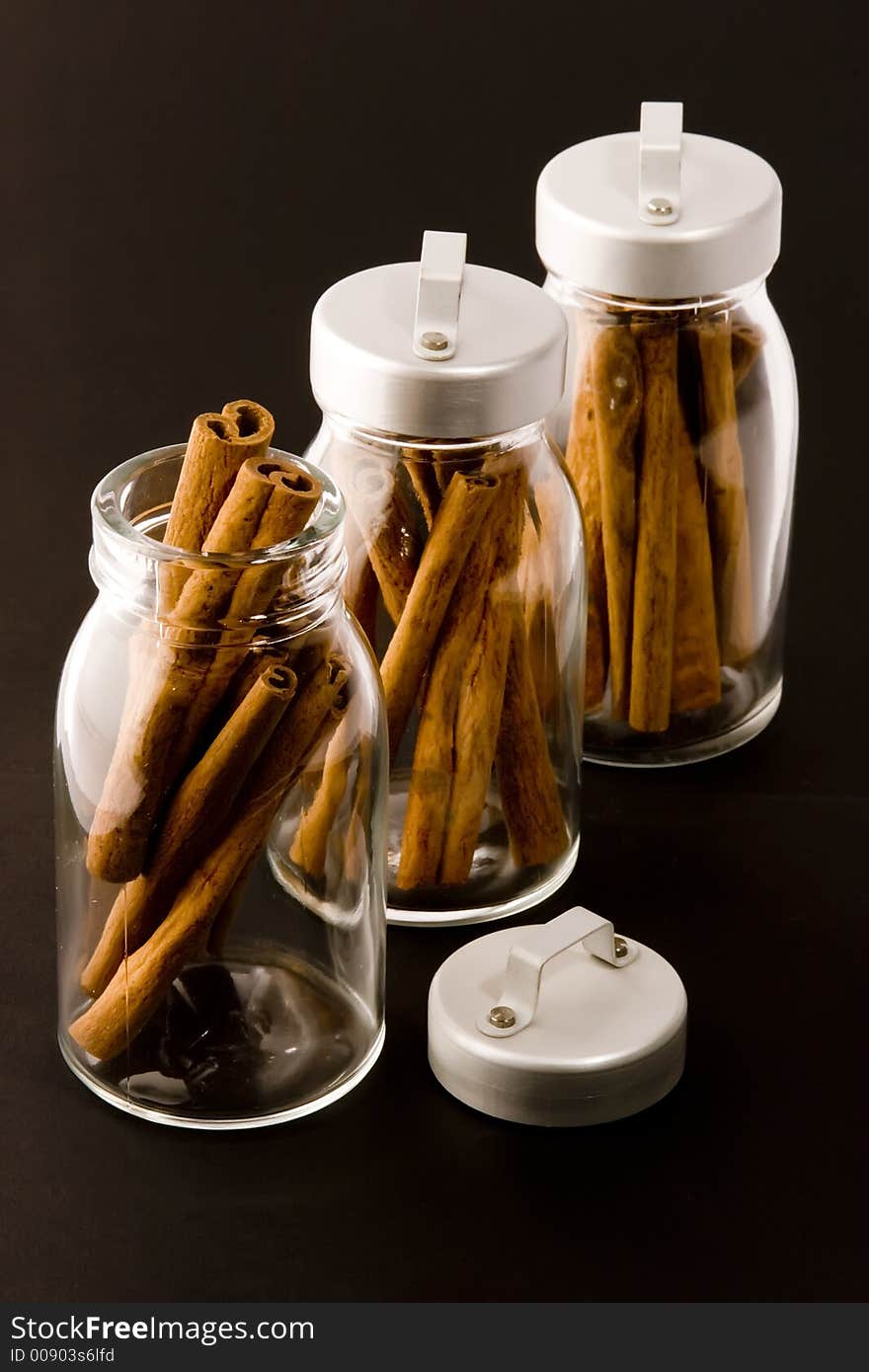 Cinnamon sticks in glass pots, studio shot, close up