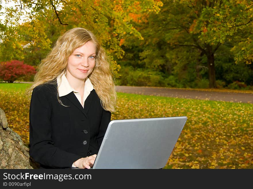 Woman with Laptop in Park.