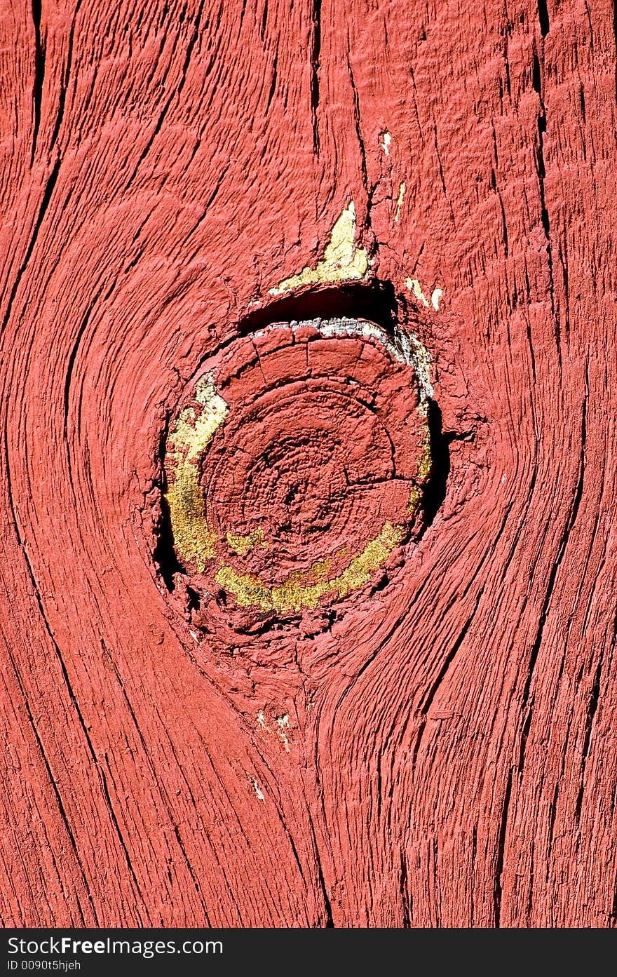 Big knot in the middle of red barn board. Big knot in the middle of red barn board.