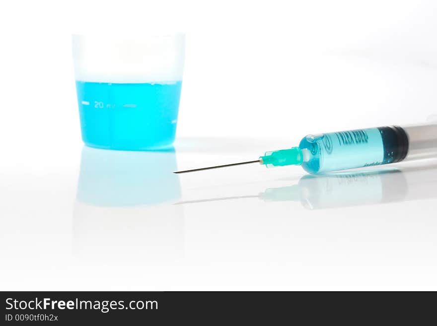 Syringe and medicin blue liquid with reflection