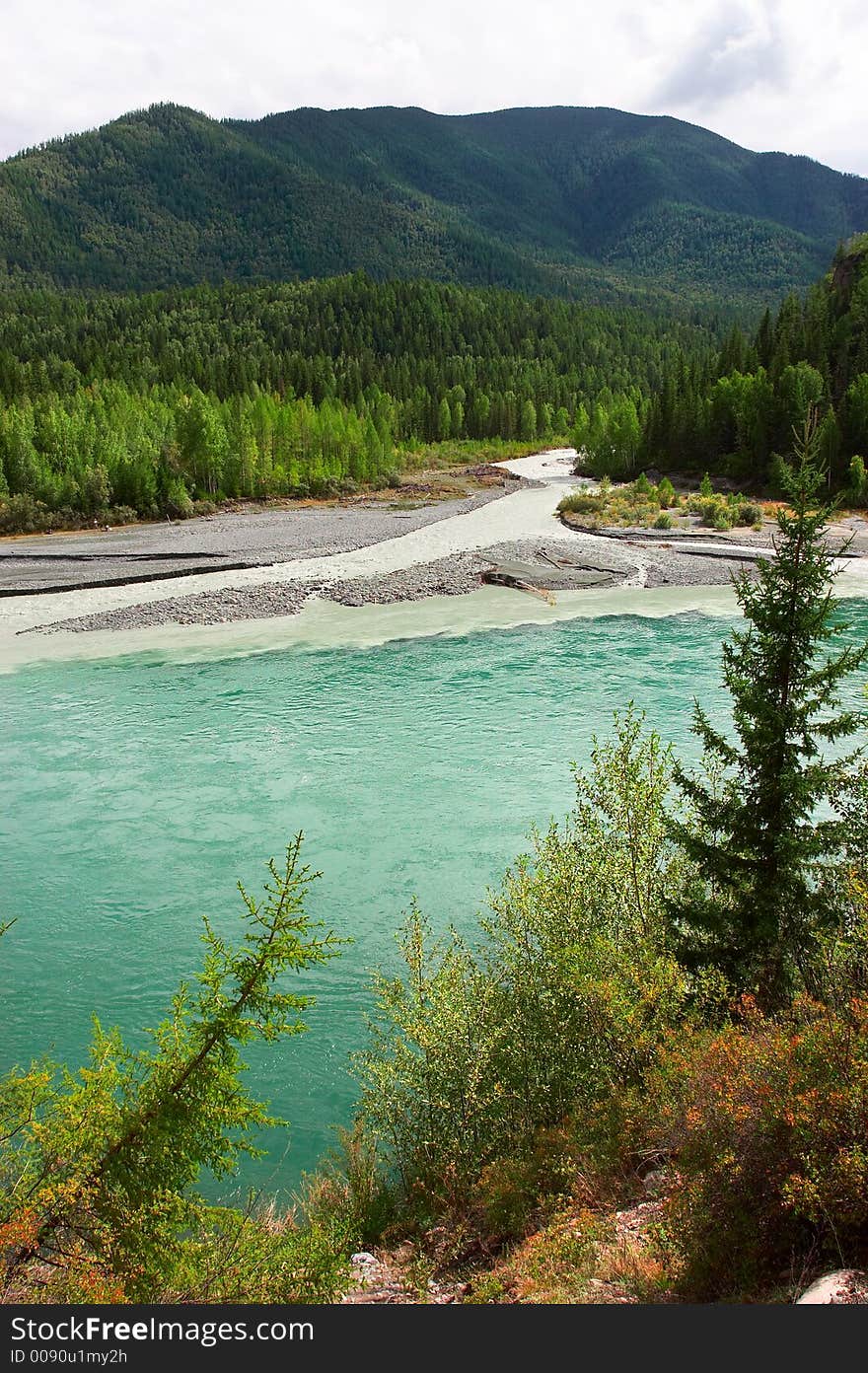 Turquoise River And Mountains.