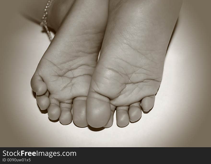 Close up shot of baby feet in sephia