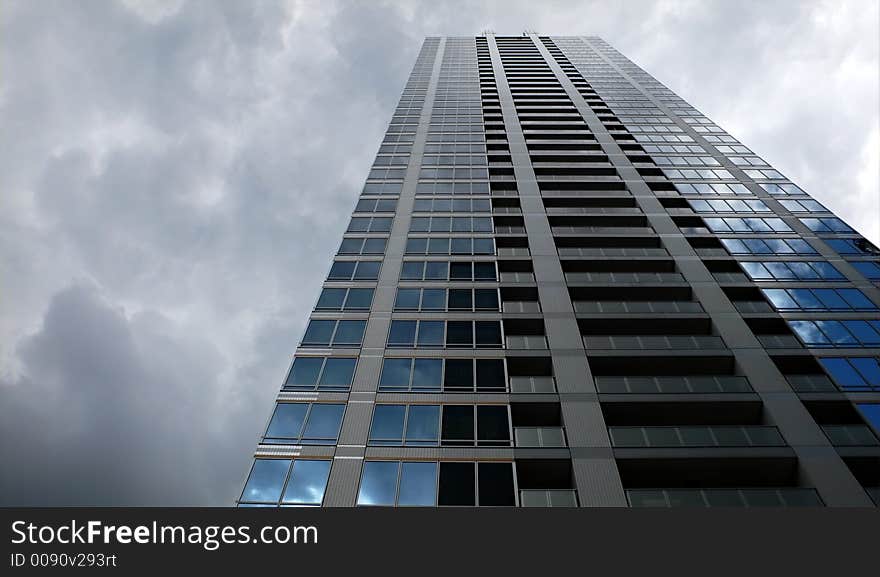 Modern up-stair building and dramatic rainy sky background. Modern up-stair building and dramatic rainy sky background