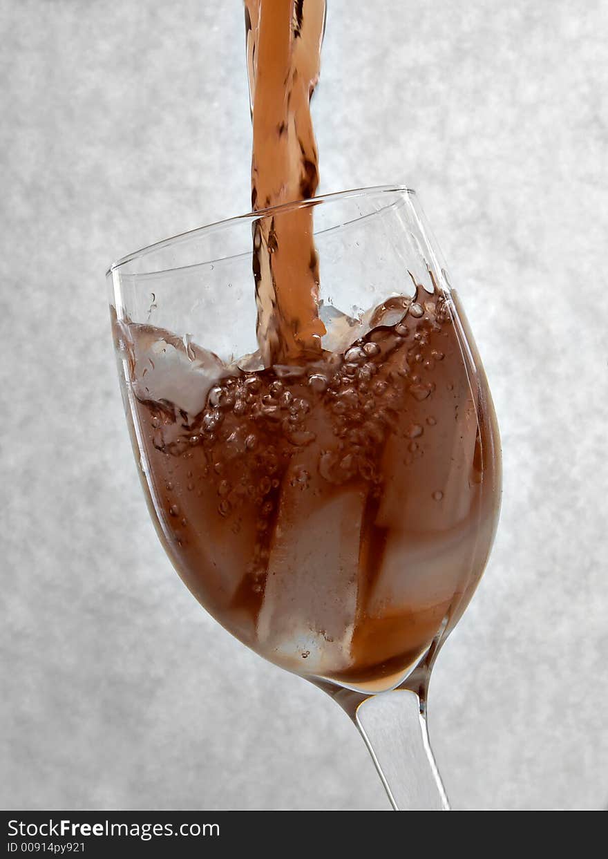 Pouring a glass of ice tea into a wine glass