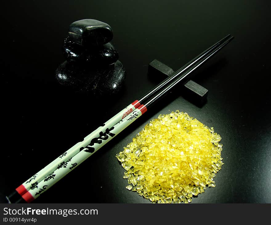 Hot stones and chopstick whit yellow rocks. Hot stones and chopstick whit yellow rocks