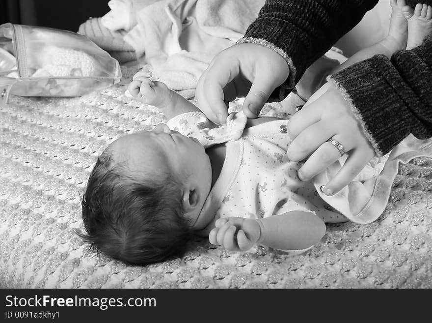 A mother changing her babies diaper. A mother changing her babies diaper