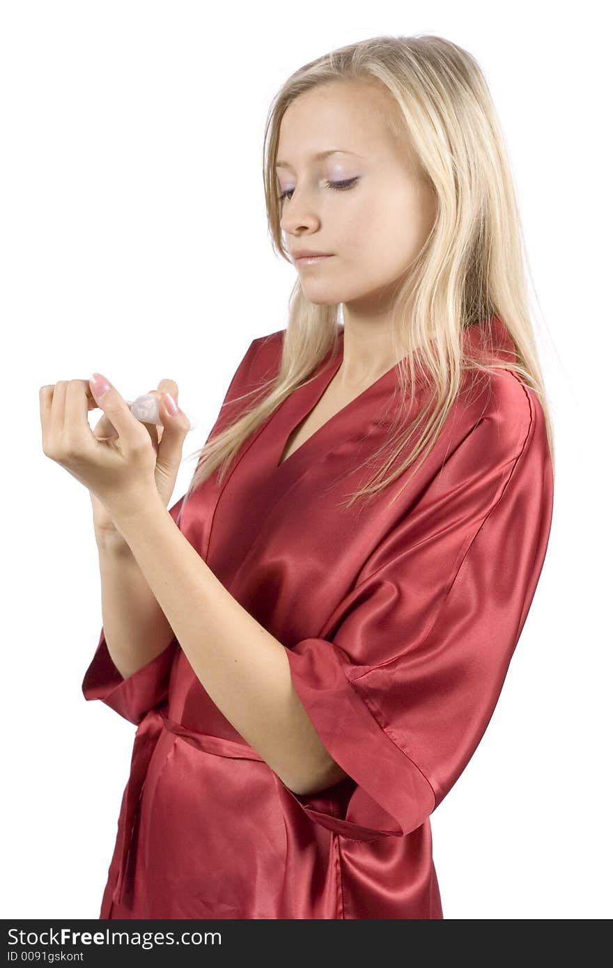 Young woman dressed red bathrobe painting nails (pure white background)