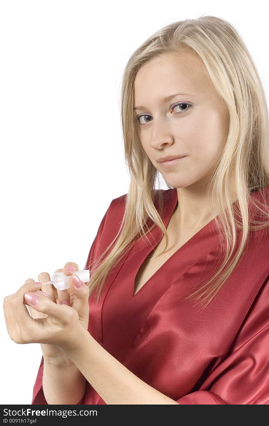 Young woman dressed red bathrobe painting nails