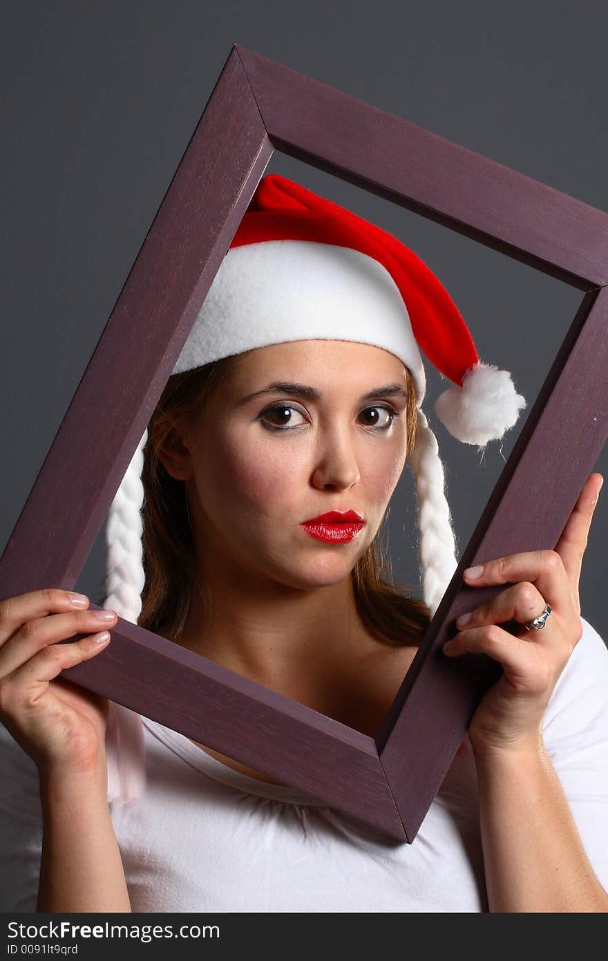 Santa girl within a wooden picture frame. Santa girl within a wooden picture frame