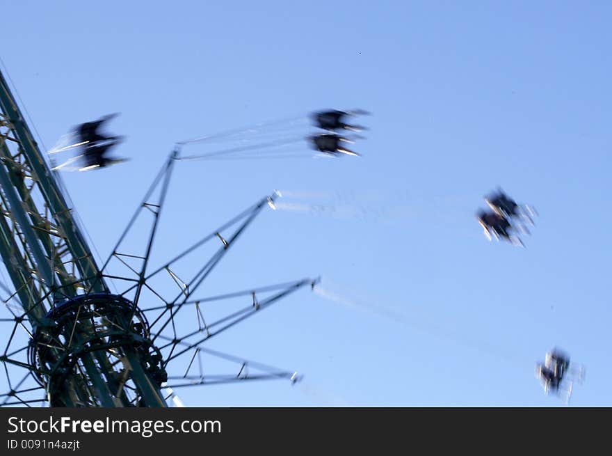 People on a fast merry-go-round; motion-blurred. People on a fast merry-go-round; motion-blurred