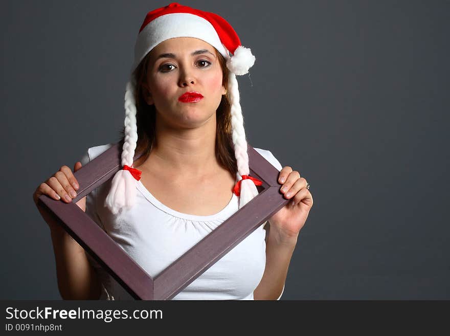 Santa girl within a wooden picture frame. Santa girl within a wooden picture frame