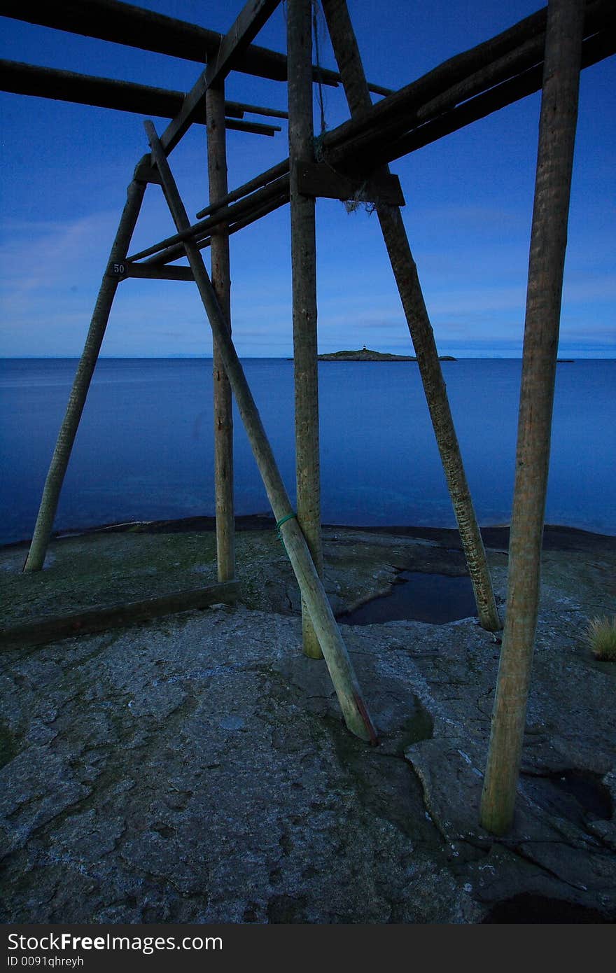 blue scenic isolated landscape of the Lofoten Islands (Norway, Norge) at midnight in summer with drying cods. blue scenic isolated landscape of the Lofoten Islands (Norway, Norge) at midnight in summer with drying cods.