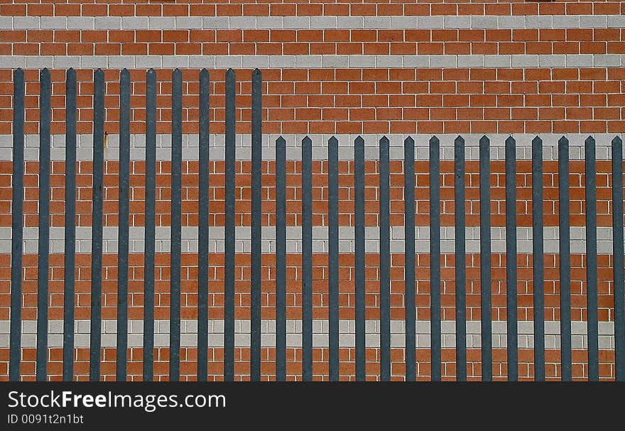 Brick wall with fence, Italy.