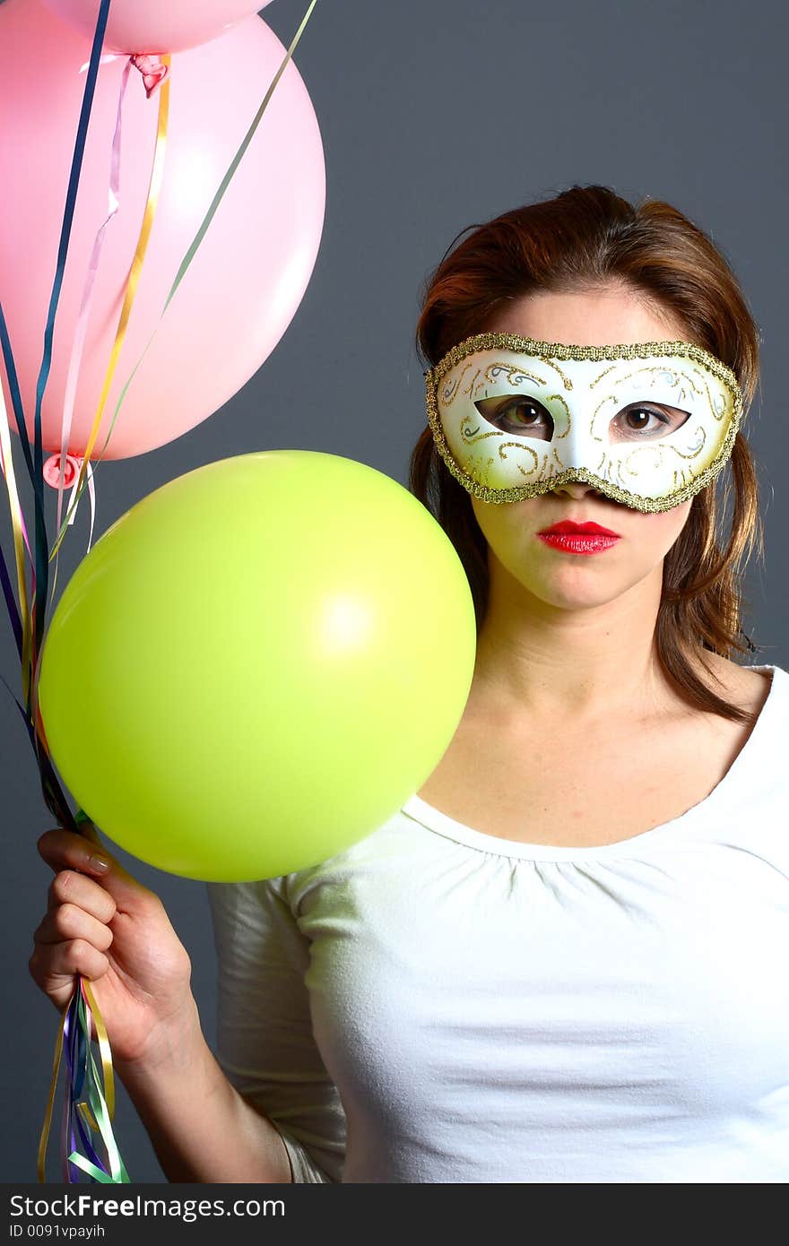 Brunette with mask and balloons