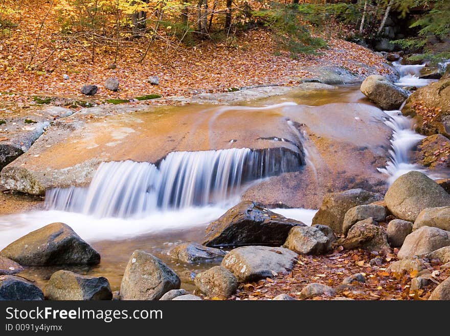 Autumn river flows over smooth rocks. Autumn river flows over smooth rocks.