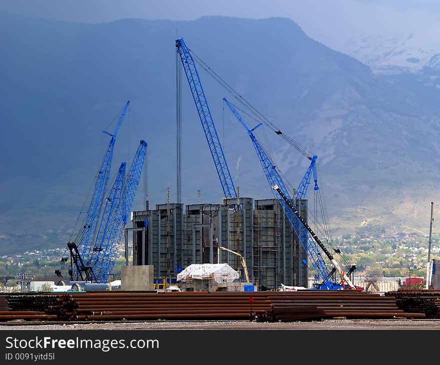 Multiple construction cranes at power plant sight. Multiple construction cranes at power plant sight.