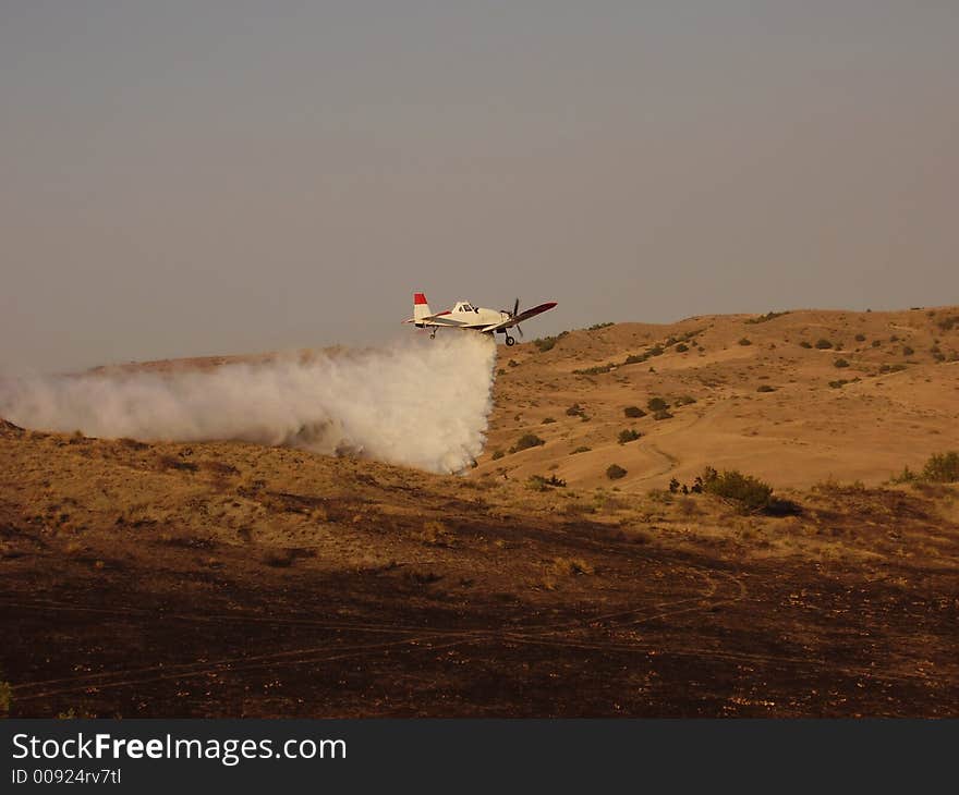 A single engine air tanker dropping a load of water. A single engine air tanker dropping a load of water