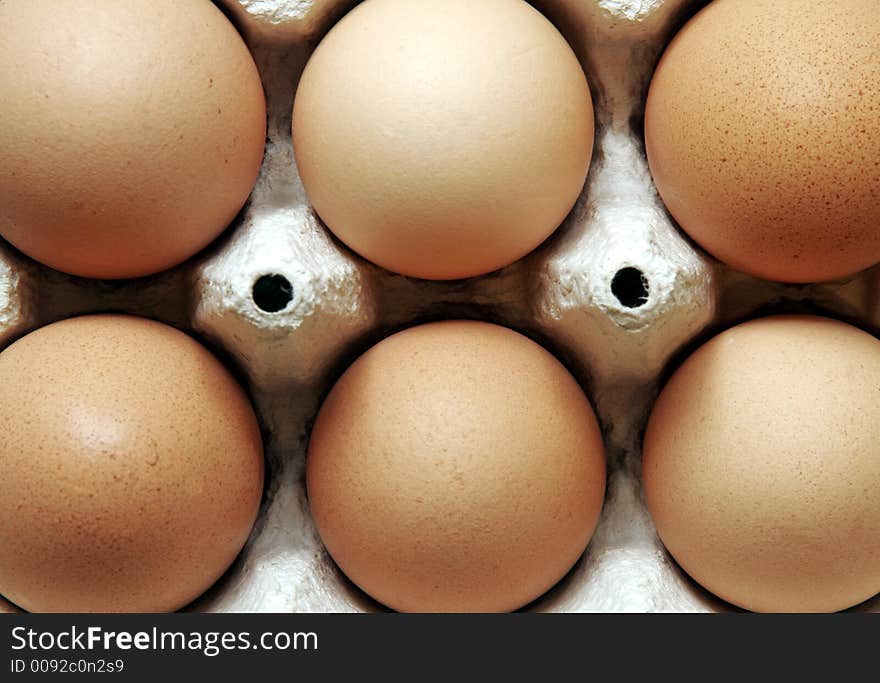 Six Brown Eggs In A Grey Cardboard Box. Six Brown Eggs In A Grey Cardboard Box