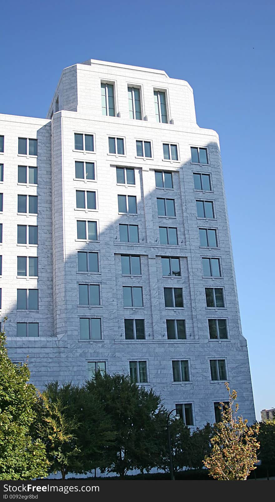 White marble office tower against blue sky. White marble office tower against blue sky