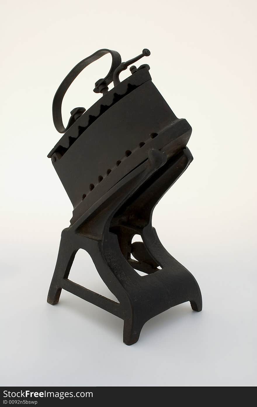 Ancient coal iron on a stand