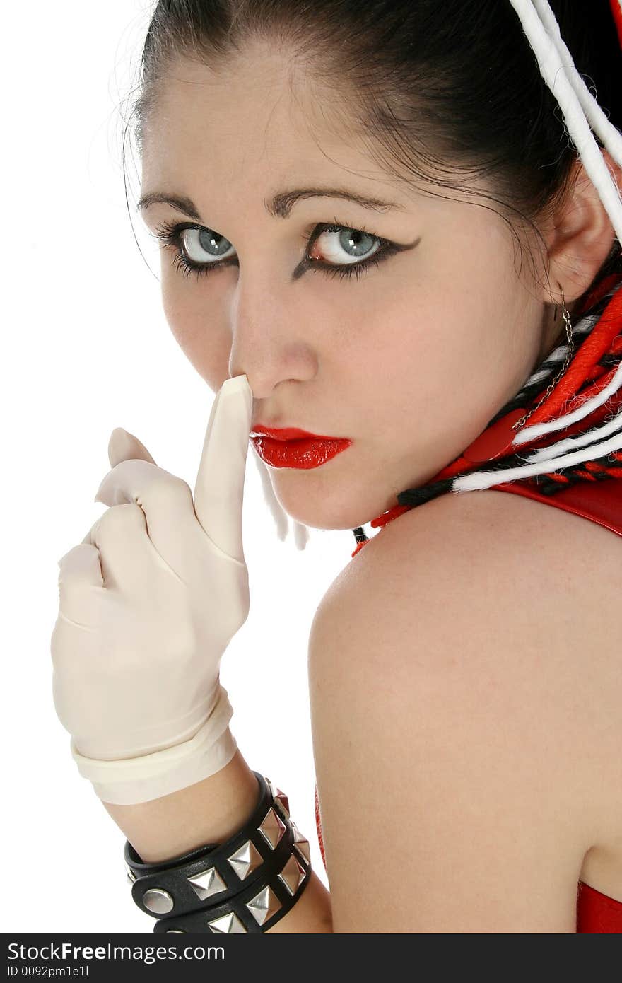 Beautiful young woman in goth dress hushing with rubber gloved hand. Beautiful young woman in goth dress hushing with rubber gloved hand.