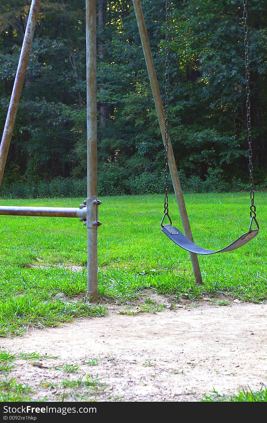 Old metal swingset in the woods. Old metal swingset in the woods