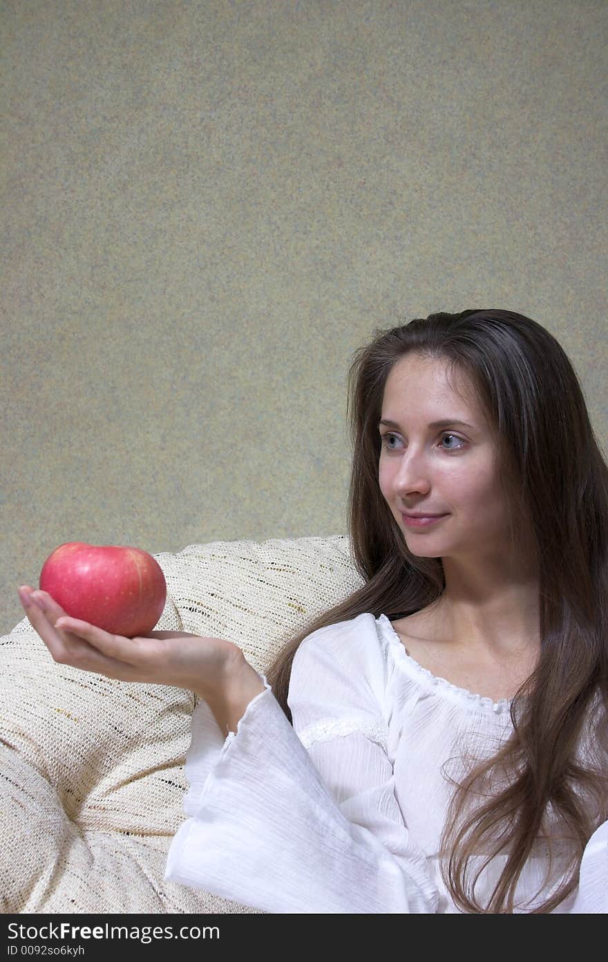 Pretty smiling woman with red apple. Portrait.