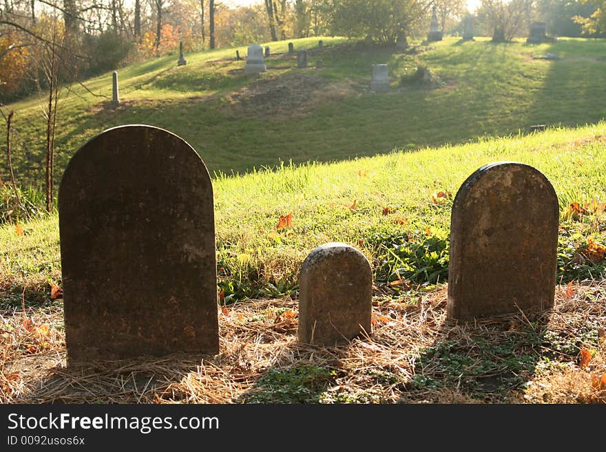 Three grave stones backlighted on a hill. Three grave stones backlighted on a hill