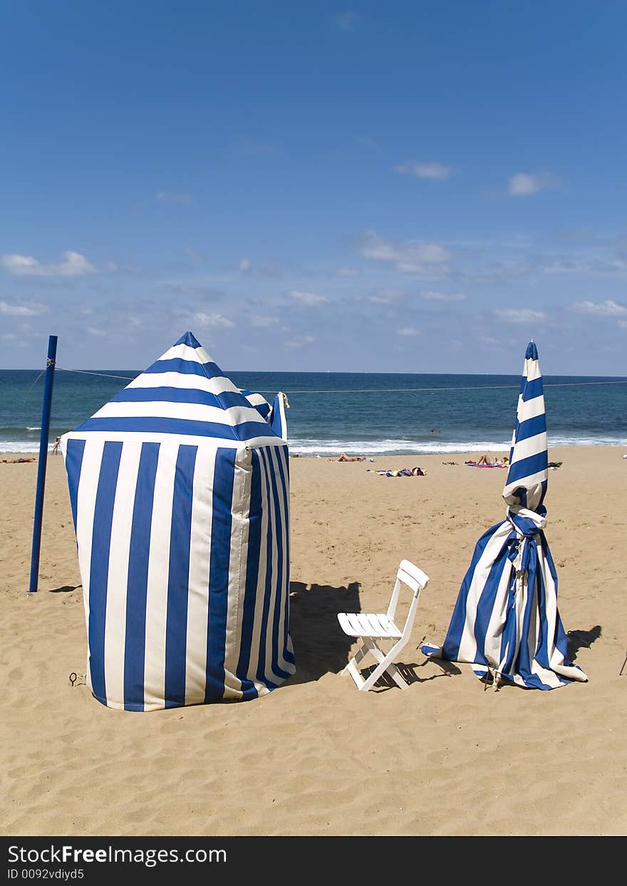 Striped blue and white beachtents on sand. Striped blue and white beachtents on sand