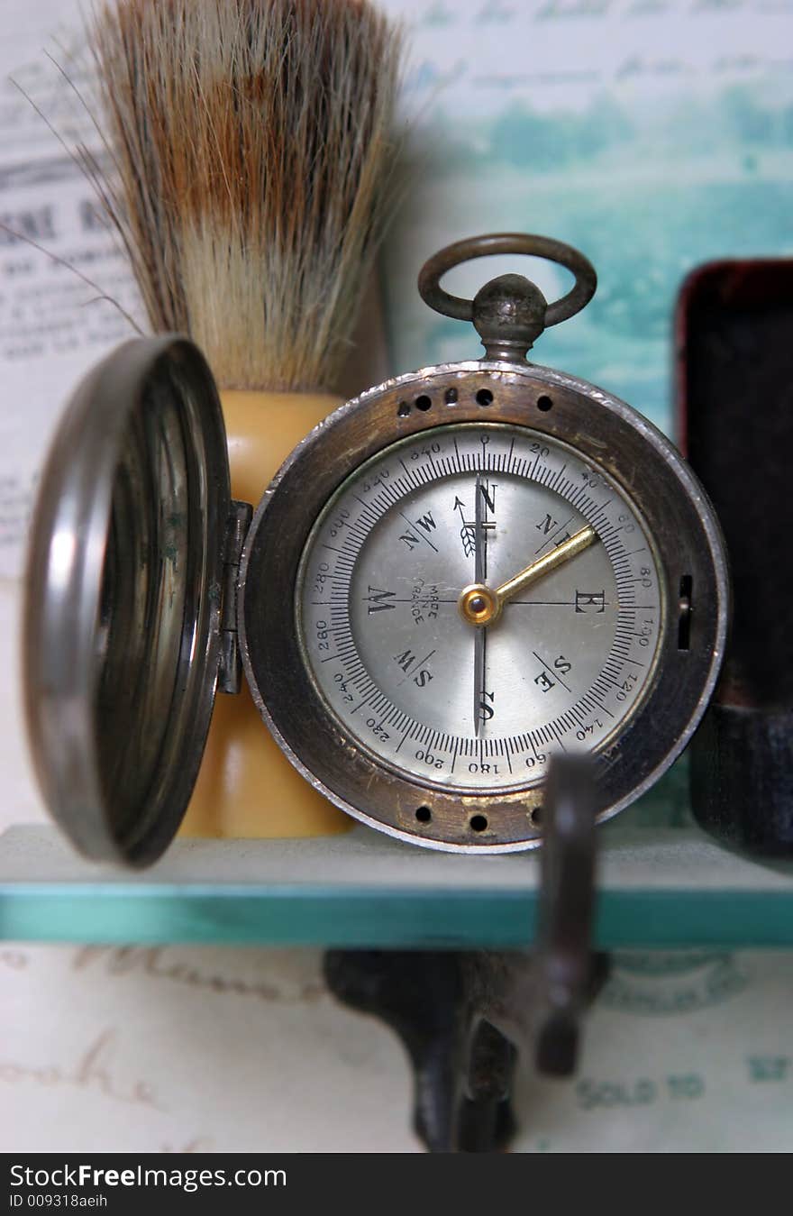 Old compass on a shelf - shallow dof. Old compass on a shelf - shallow dof