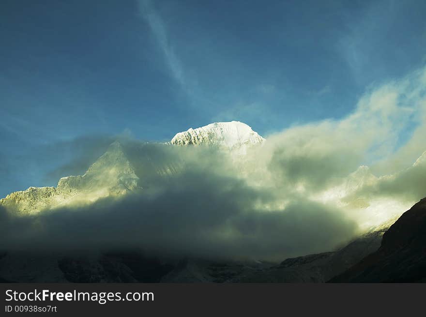 Snowcowered high cordillera mountain and mist. Snowcowered high cordillera mountain and mist